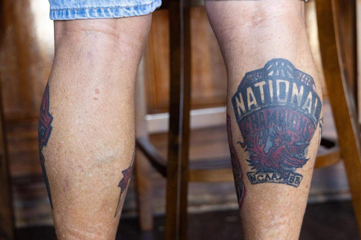 South Carolina Gamecocks fan Rocky Easterling shows off his multiple tattoos celebrating the women’s basketball team’s multiple NCAA National Championship wins at the nearby Colonial Life Arena at Thirsty Fellow on Friday, March 21, 2025. Easterling told head coach Dawn Staley that if they won a championship, he would get a tattoo for it, and has held to his word.