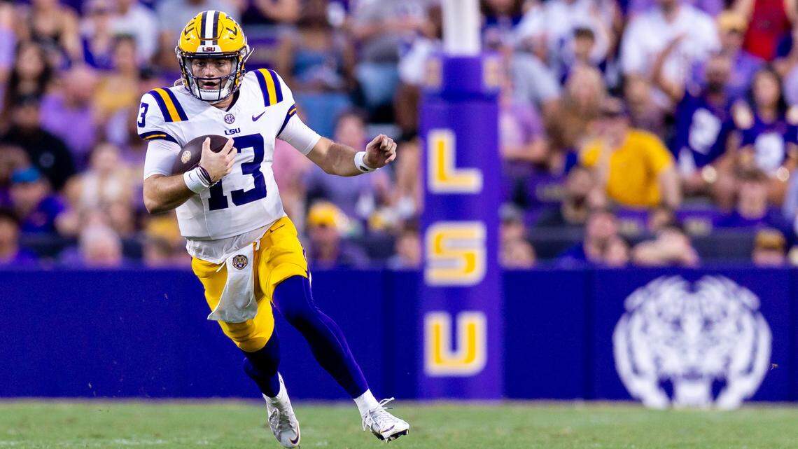 LSU Tigers quarterback Garrett Nussmeier (13) scrambles out the pocket against the Nicholls State Colonels during the first half at Tiger Stadium.