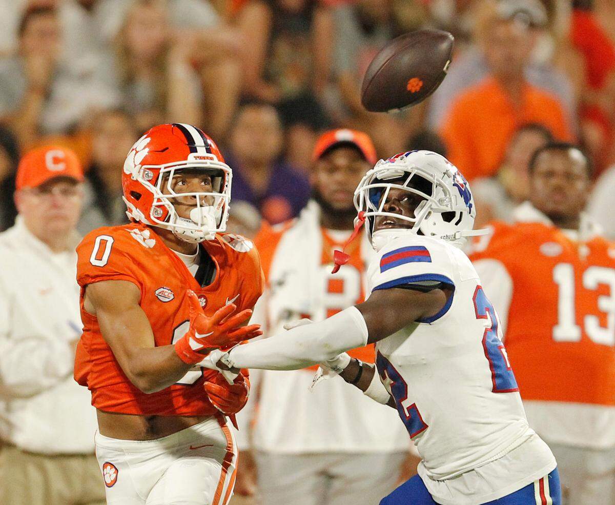 Clemson wide receiver Antonio Williams (0) reels in a throw against Louisiana Tech defensive back Willie Roberts (22) during second-quarter action in Clemson, S.C. on Saturday, Sept. 17, 2022.