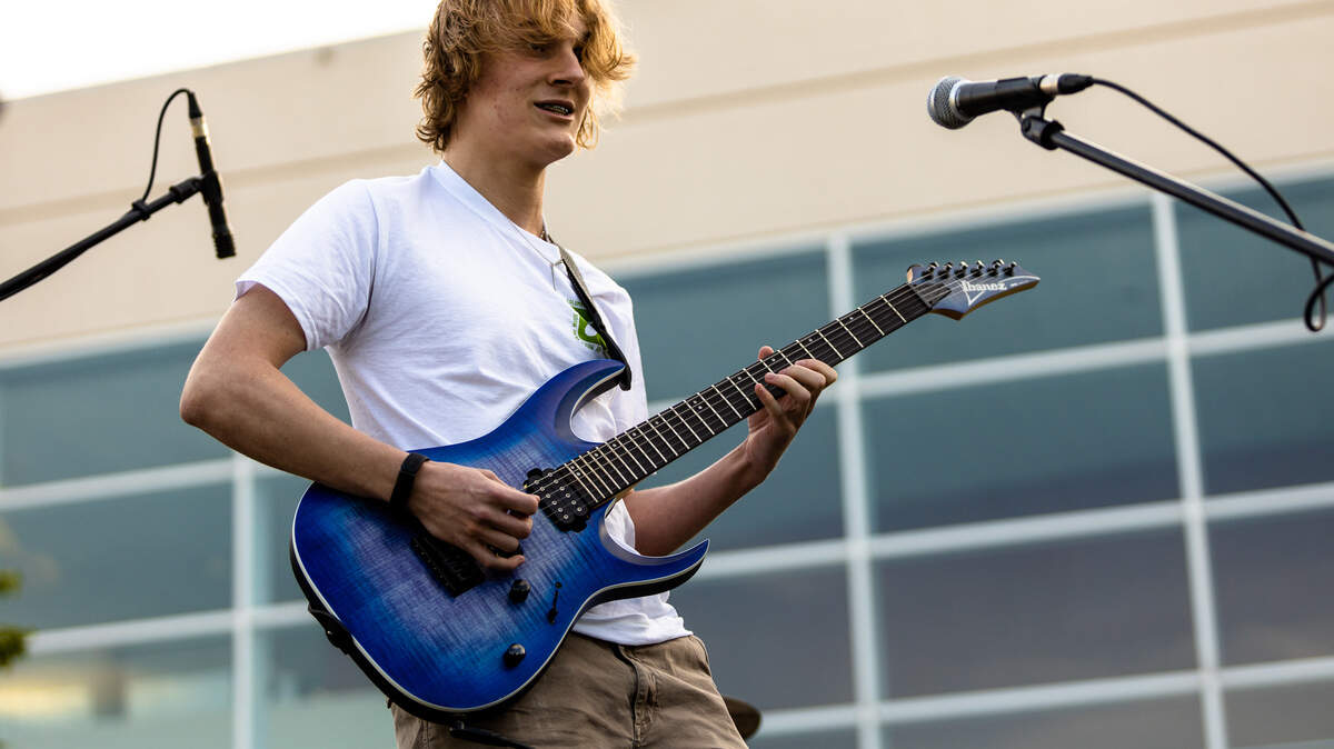 Shane Manning, a Columbia Arts Academy student, plays guitar.