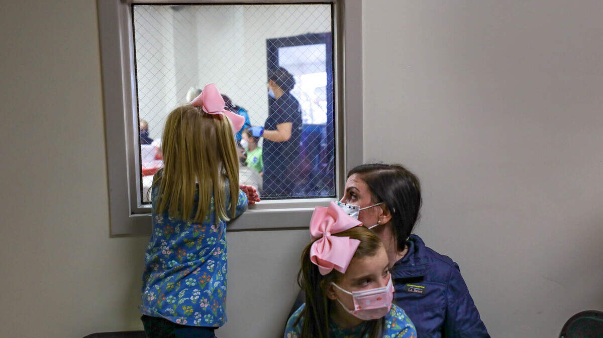 Lola Greiner, 3, left, watches children get vaccinated for the Coronavirus as her sister, Ella Greiner and mother, Angelica Greiner wait their turn at Prisma Health on Thursday, Nov. 4, 2021.