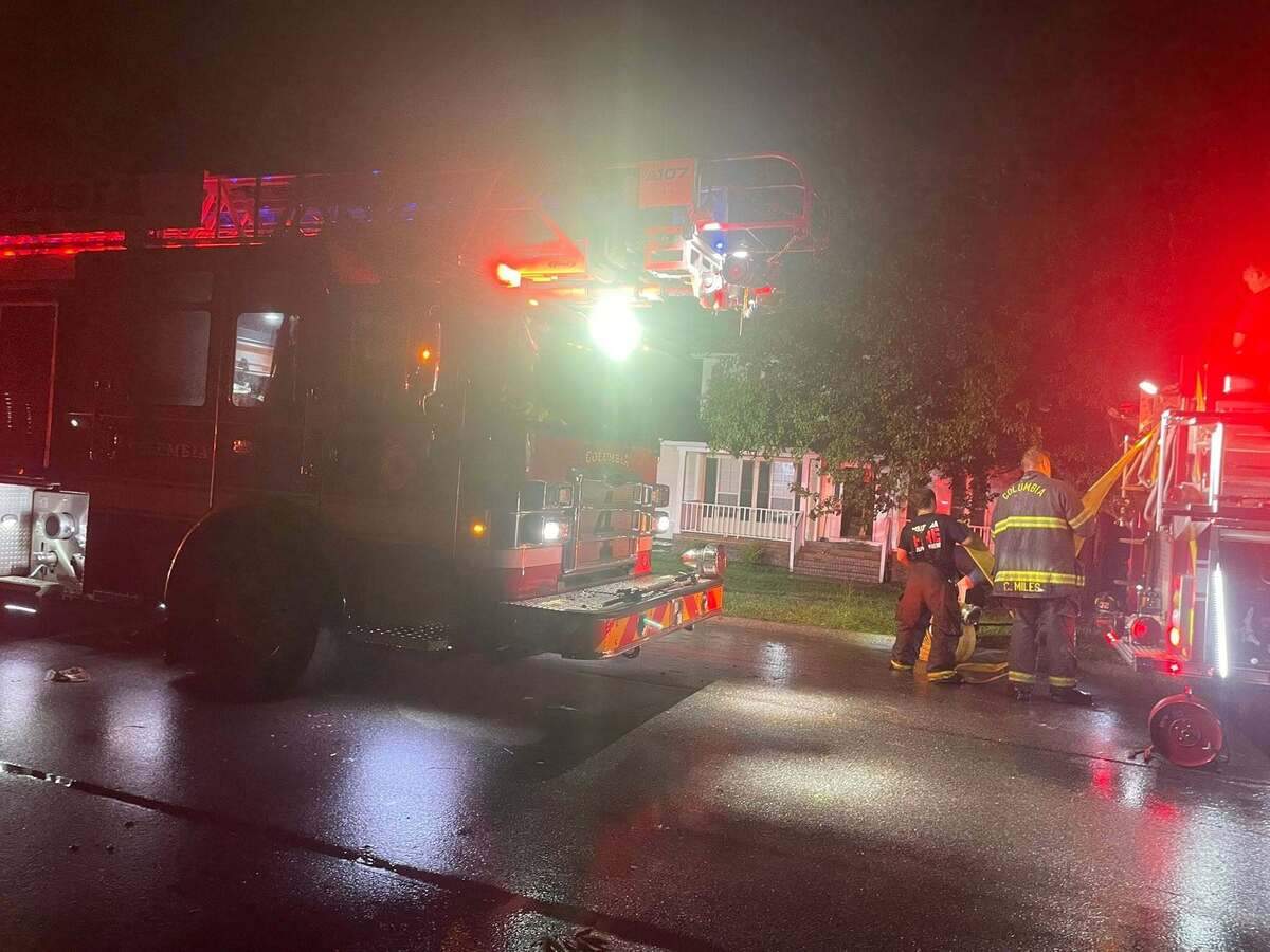 Members of the Columbia Fire Department respond to a house fire.