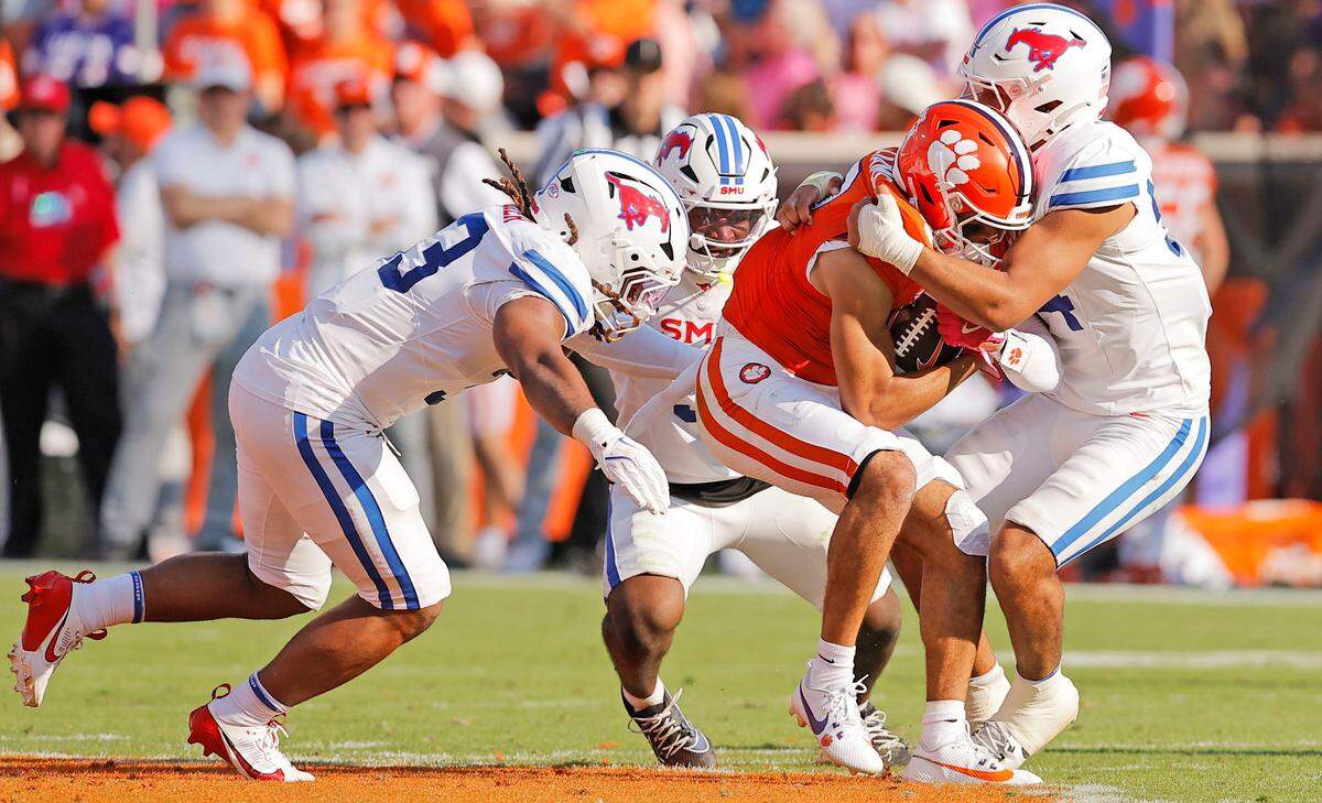 Clemson wide receiver Antonio Williams (0) is wrapped up by SMU during first-half action in Clemson, S.C on Saturday, Oct. 18, 2025.