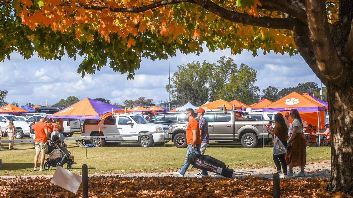 Nov 2, 2024; Clemson, South Carolina, USA; Fall colors surround football fans tailgating before a game between the Clemson Tigers and the Louisville Cardinals at Memorial Stadium.
