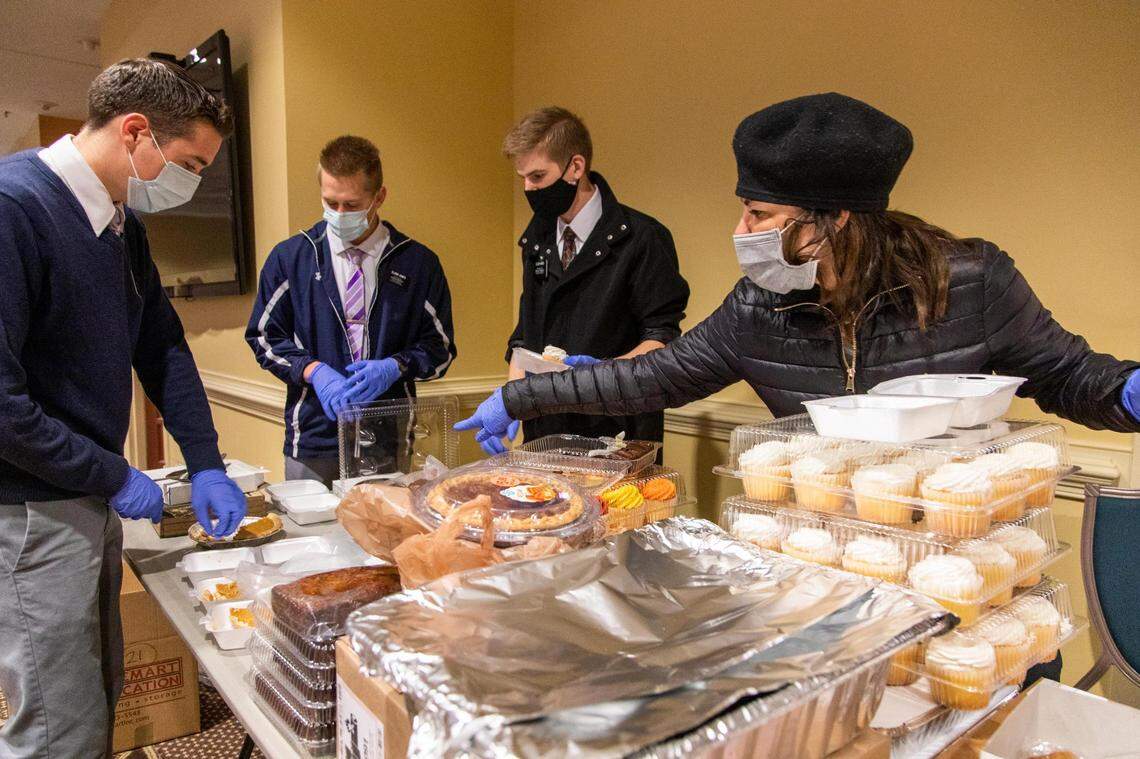 Missionairies from the Church of Latter Day Saints divide deserts for Thanksgiving lunches at The Basilica of St. Peter in downtown Columbia, South Carolina on Thursday, November 26, 2020. Traditionally the church’s Thanksgiving meal is help at the Carolina Coliseum, but due to measures to help stop the spread of the coronavirus, the church decided to give take-away meals at the church.