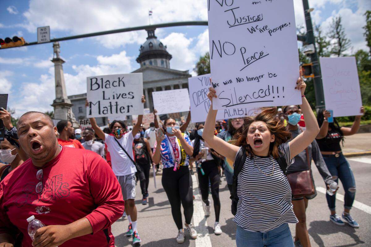 Protesters move up Main Street as they march the streets of Columbia Sunday. May 31, 2020