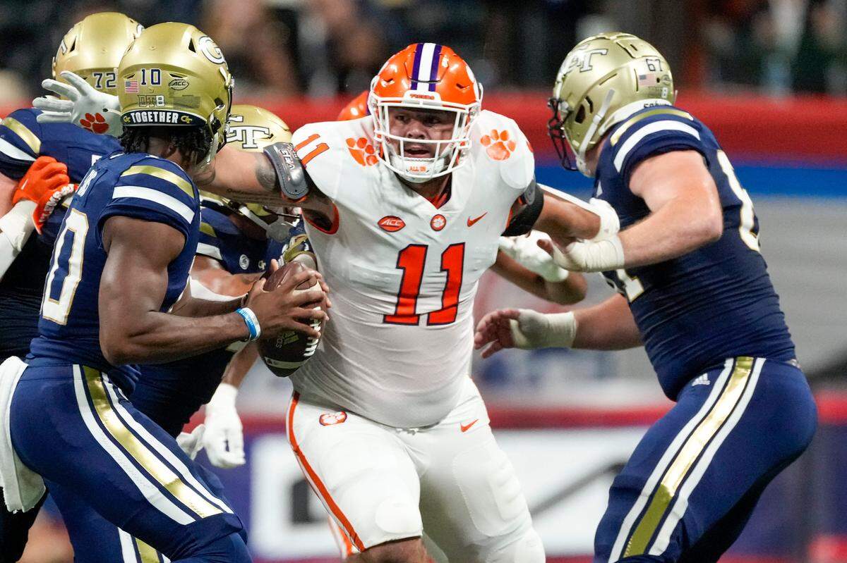 Clemson Tigers defensive tackle Bryan Bresee (11) goes after Georgia Tech Yellow Jackets quarterback Jeff Sims (10) during the 2022 Chick-fil-A Kickoff Game, Monday, Sept. 5, 2022, in Atlanta.