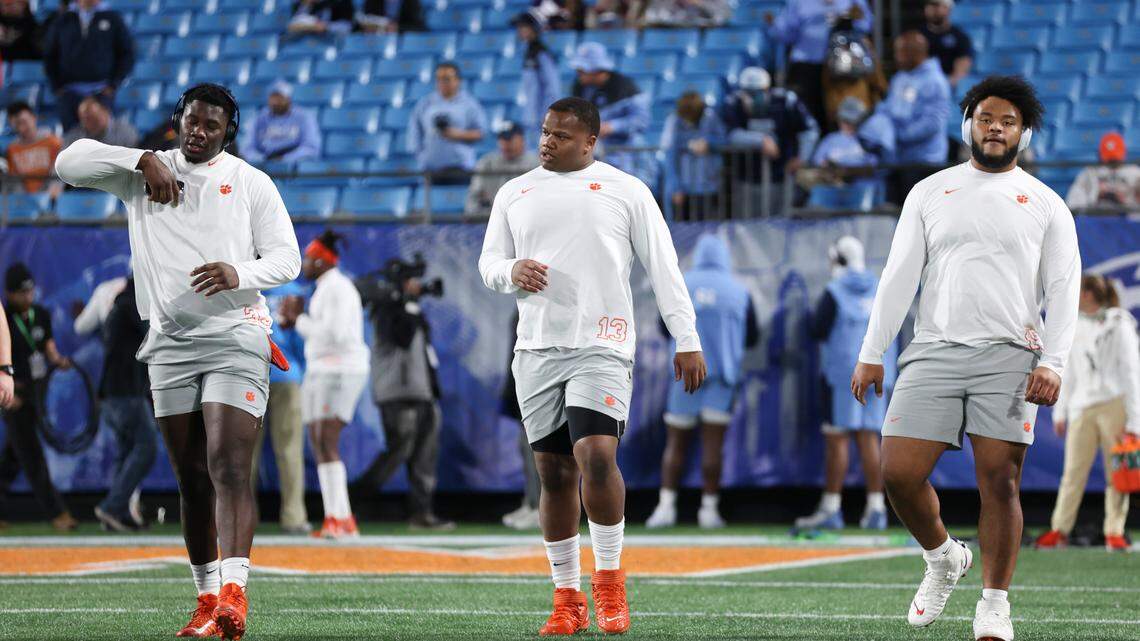 Clemson Tigers football players Ruke Orhorhoro (left), Tyler Davis (middle) and Payton Page (right) warm up before the 2022 ACC Championship in Charlotte, N.C., Saturday, Dec. 3, 2022. (Photo by Taylor Banner/ACC)