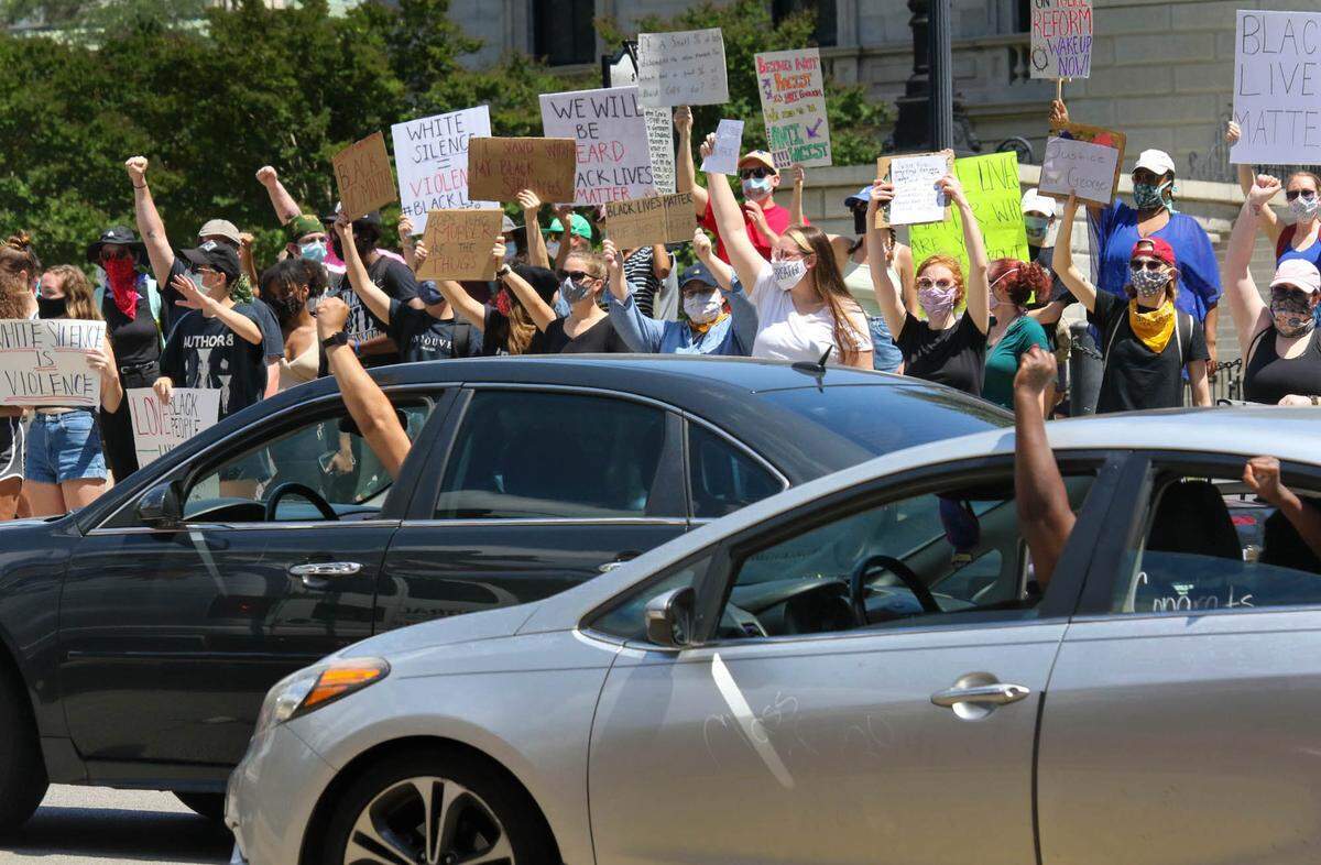 Motorists show their support as demonstrators stand at the South Carolina Statehouse in Columbia to show their anger at how George Floyd was killed while being arrested in Minneapolis.
