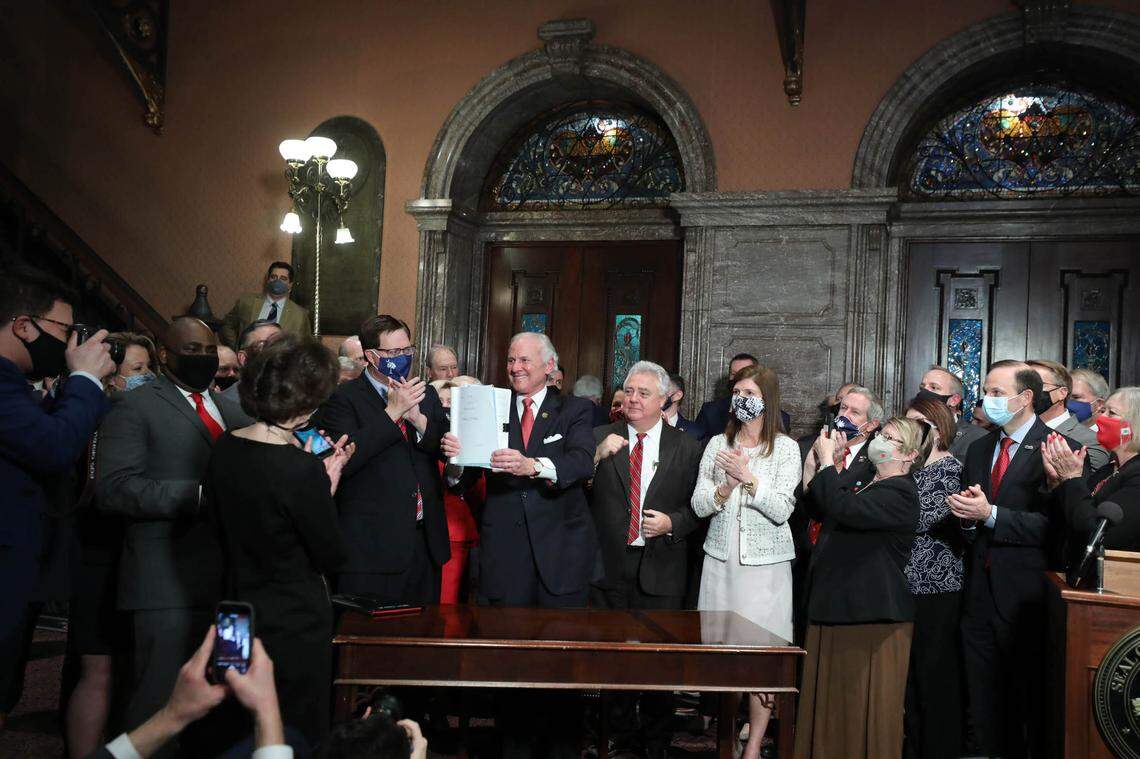 South Carolina Gov. Henry McMaster celebrates the signing of the fetal heartbeat bill into law during a ceremony at the Statehouse on Thursday, Feb. 18, 2021.