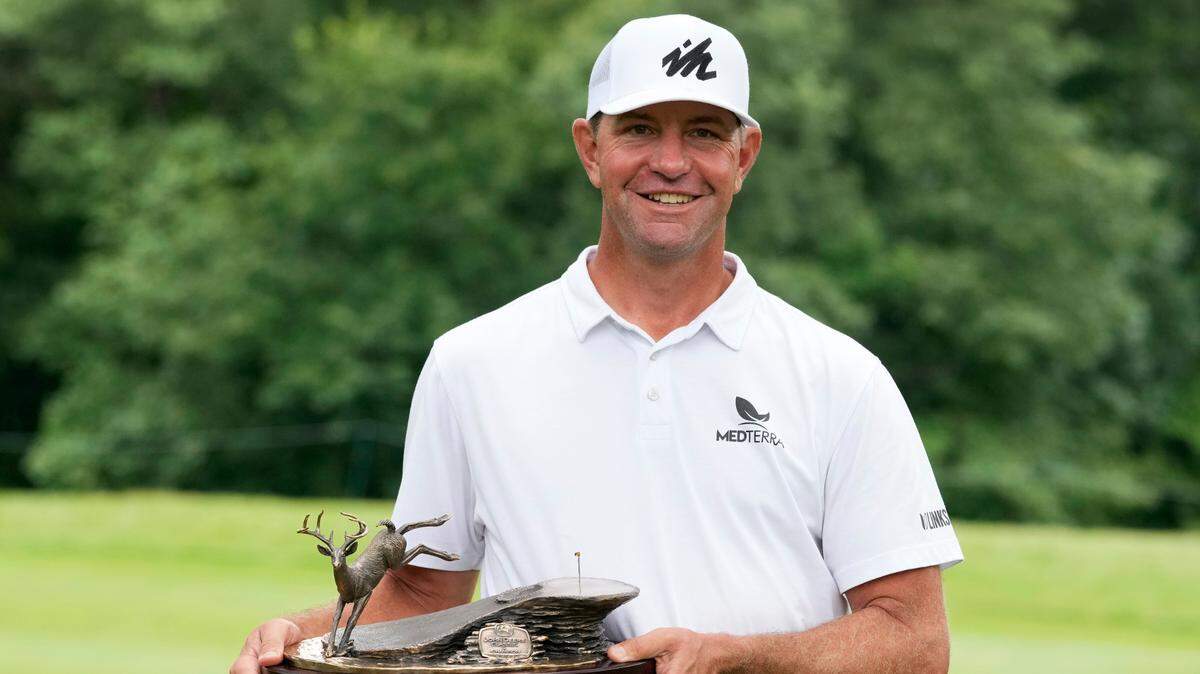 Lucas Glover holds the trophy after winning the John Deere Classic golf tournament, Sunday, July 11, 2021, at TPC Deere Run in Silvis, Ill. (AP Photo/Charlie Neibergall)