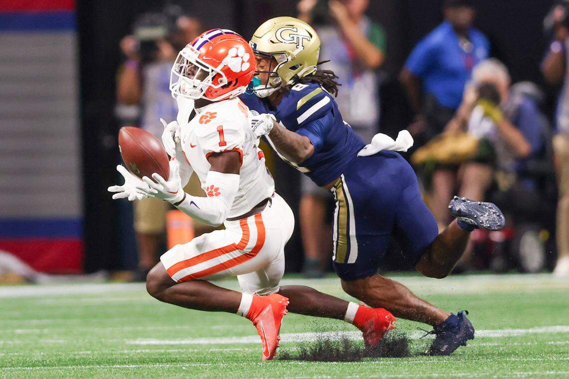 Clemson Tigers safety Andrew Mukuba (1) intercepts the ball against Georgia Tech Yellow Jackets wide receiver Nate McCollum (8) during the 2022 Chick-fil-A Kickoff Game, Monday, Sept. 5, 2022, in Atlanta.