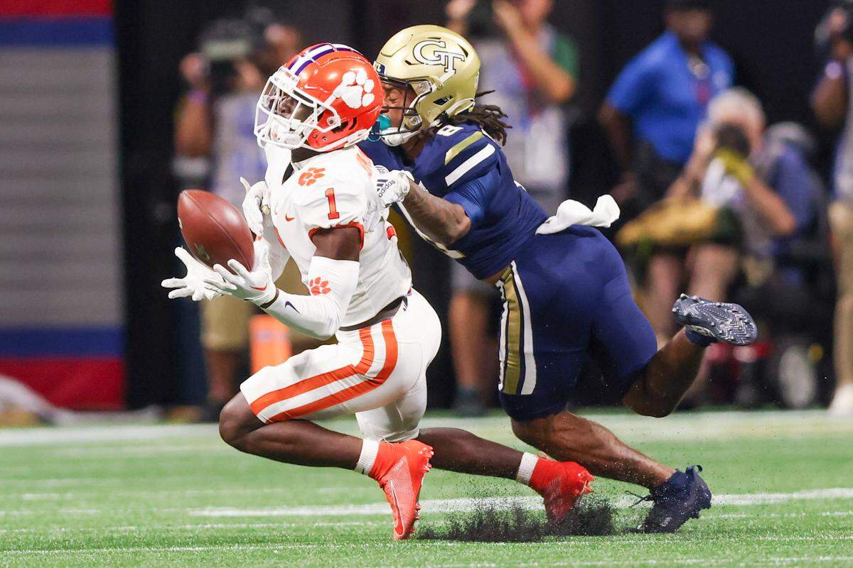Clemson Tigers safety Andrew Mukuba (1) intercepts the ball against Georgia Tech Yellow Jackets wide receiver Nate McCollum (8) during the 2022 Chick-fil-A Kickoff Game, Monday, Sept. 5, 2022, in Atlanta.