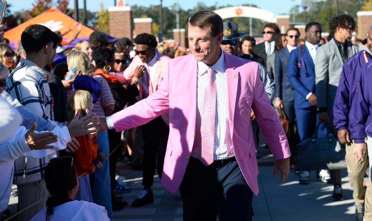 Oct 19, 2024; Clemson, South Carolina, USA; Clemson Tigers head coach Dabo Swinney, center, welcomes fans during Tiger Walk prior to the game against the Virginia Cavaliers at Memorial Stadium.