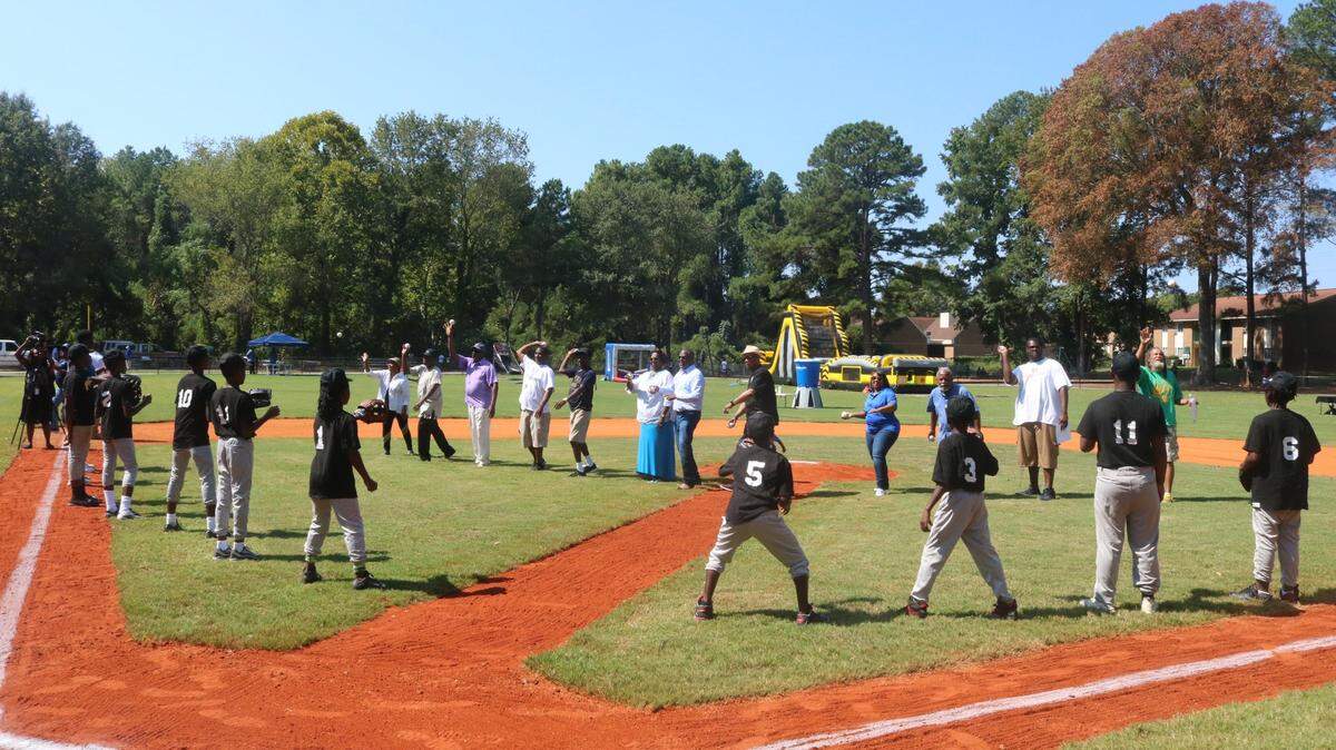 Elected officials and neighborhood leaders throw out first pitches in at the Sept. 2019 opening of All-Stars Field near Lester Drive in Columbia. City Council has now approved $169,000 for lights for the field.