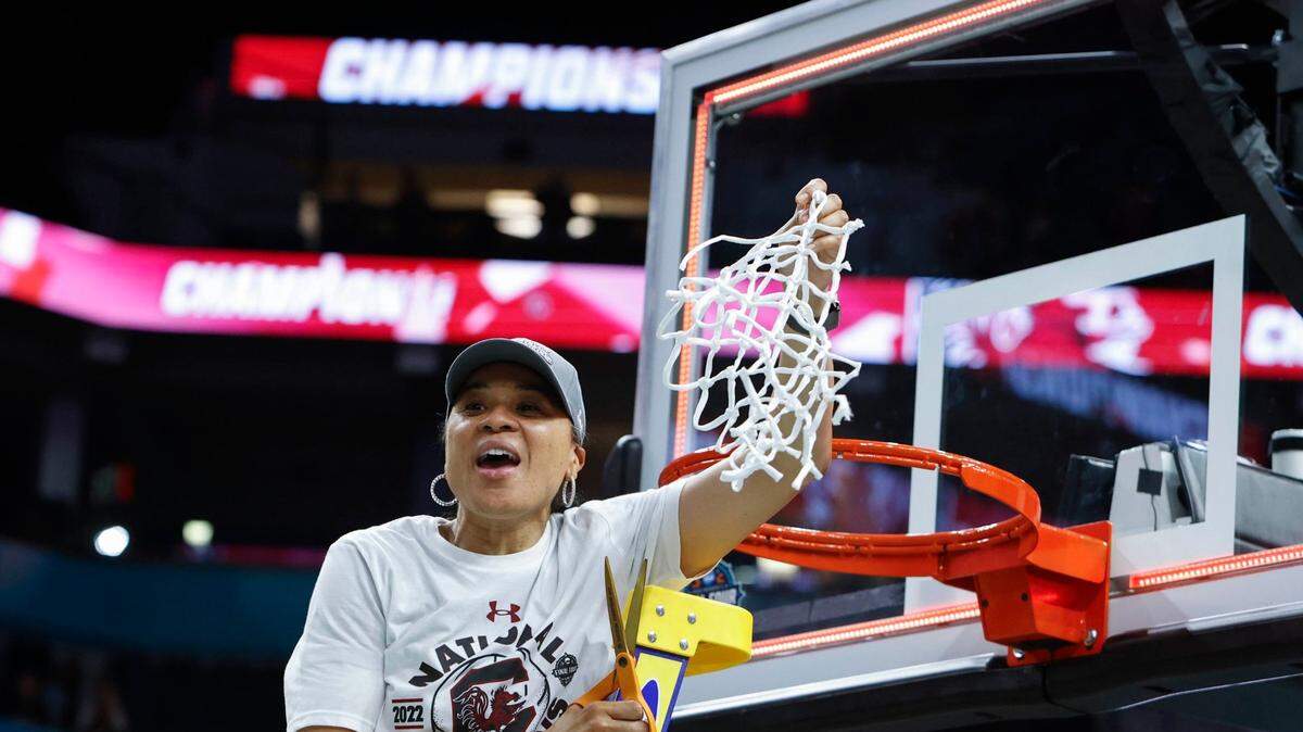 University of South Carolina Head Coach Dawn Staley celebrates with the net after winning the national championship against UConn at the Target Center in Minneapolis, Minn. on Sunday April 3, 2022.