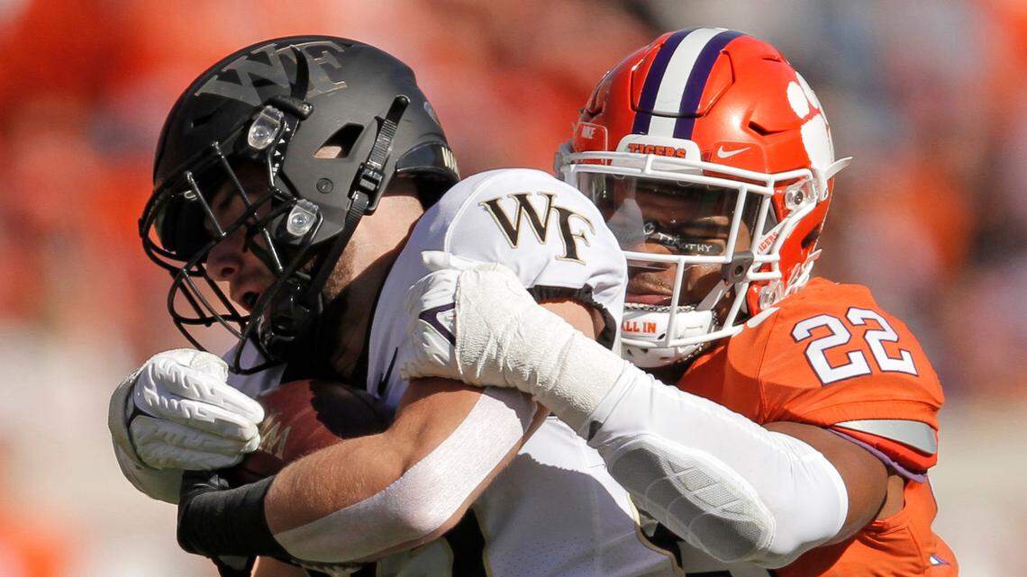 Clemson linebacker Trenton Simpson (22) wraps up Wake Forest wide receiver Taylor Morin (83) during first-quarter action in Clemson, S.C. on Saturday.
