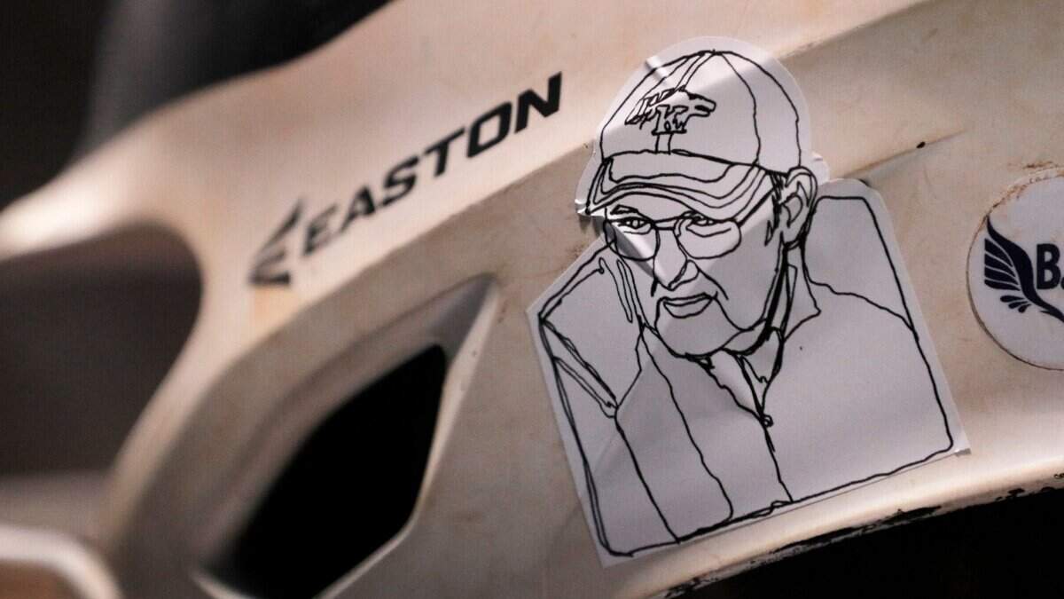 Every White Knoll softball player has a sticker on their helmet in honor of late former assistant coach Richard Lundy during their game against Chapins softball team on Tuesday, March 29, 2022 at White Knoll High School.