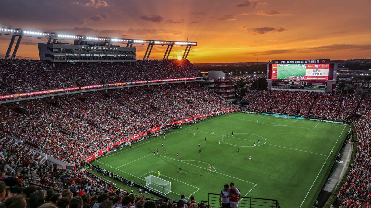 The sun sets over Williams-Brice Stadium as soccer fans watch the Premier League soccer match between Manchester United and Liverpool on Saturday, Aug. 3, 2024.