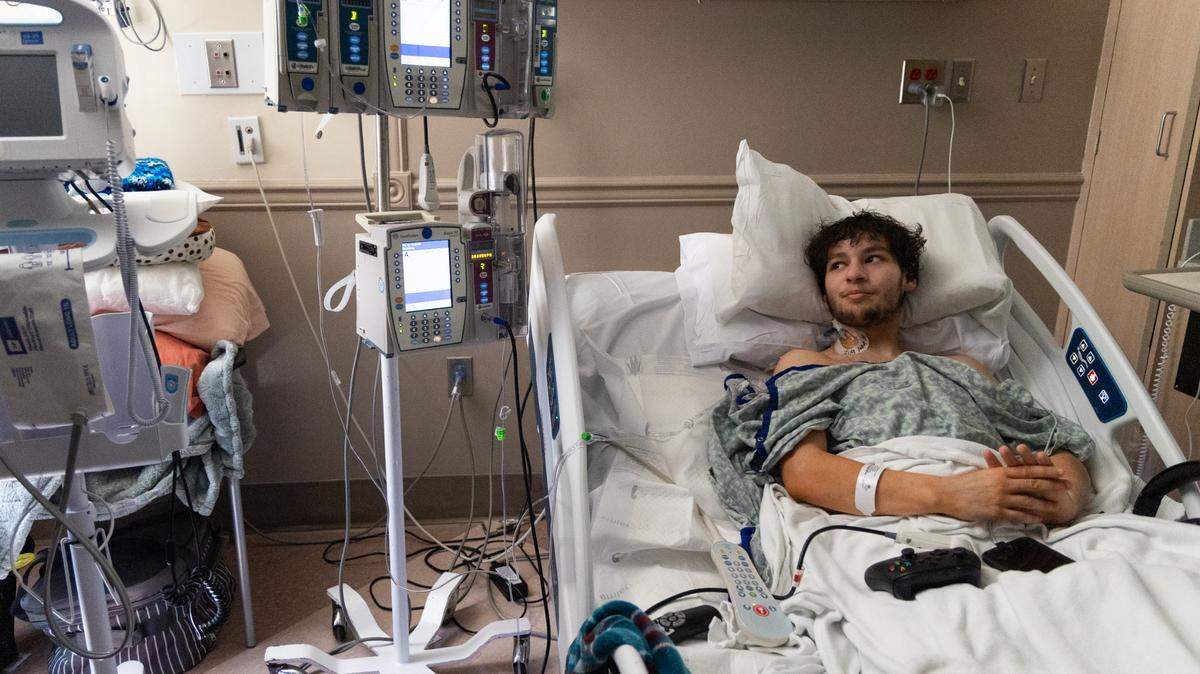 JJ Haselbarth rests in his hospital room at Prisma Richland Hospital on Wednesday, March 19, 2025. While Haselbarth was driving to work on February 20, his car spun out of control and collided with a guard rail, severing his right leg and injuring his left.