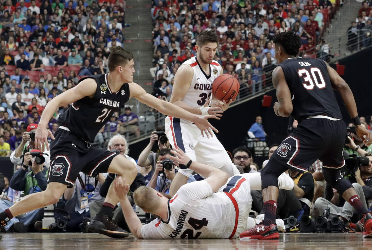 Gonzaga’s Killian Tillie (33) grabs a loose ball against South Carolina’s Maik Kotsar (21) as Gonzaga’s Przemek Karnowski (24) and South Carolina’s Chris Silva (30) watch during the first half in the semifinals of the Final Four on April 1, 2017, in Glendale, Arizona.