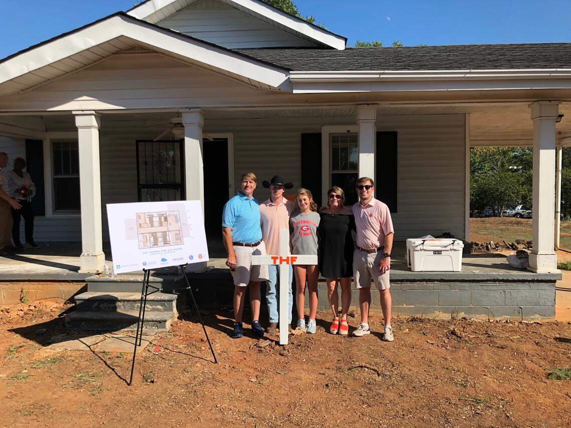 The Few family stands outside the H2O House before construction began. From left, Wes, MacRae, MaryWesley, Kimberly and Evans.