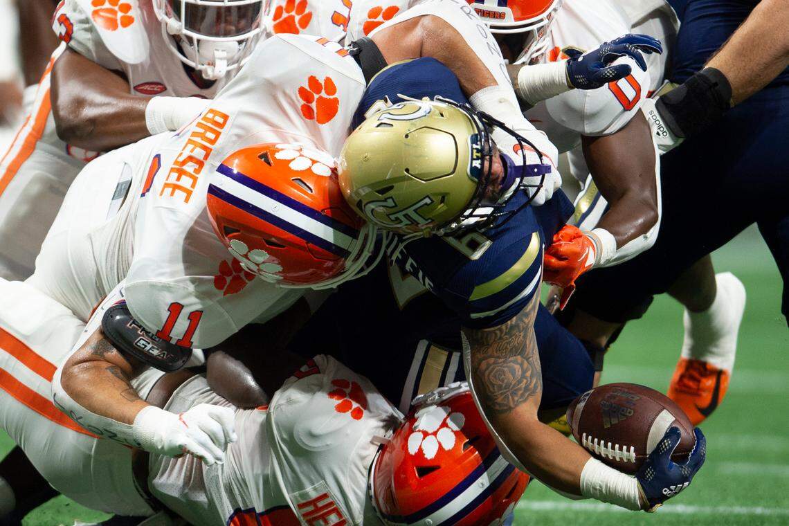 Clemson defensive tackle Bryan Bresee (11) tackles Georgia Tech running back Dylan McDuffie (6) in the first half of an NCAA college football game Monday in Atlanta.