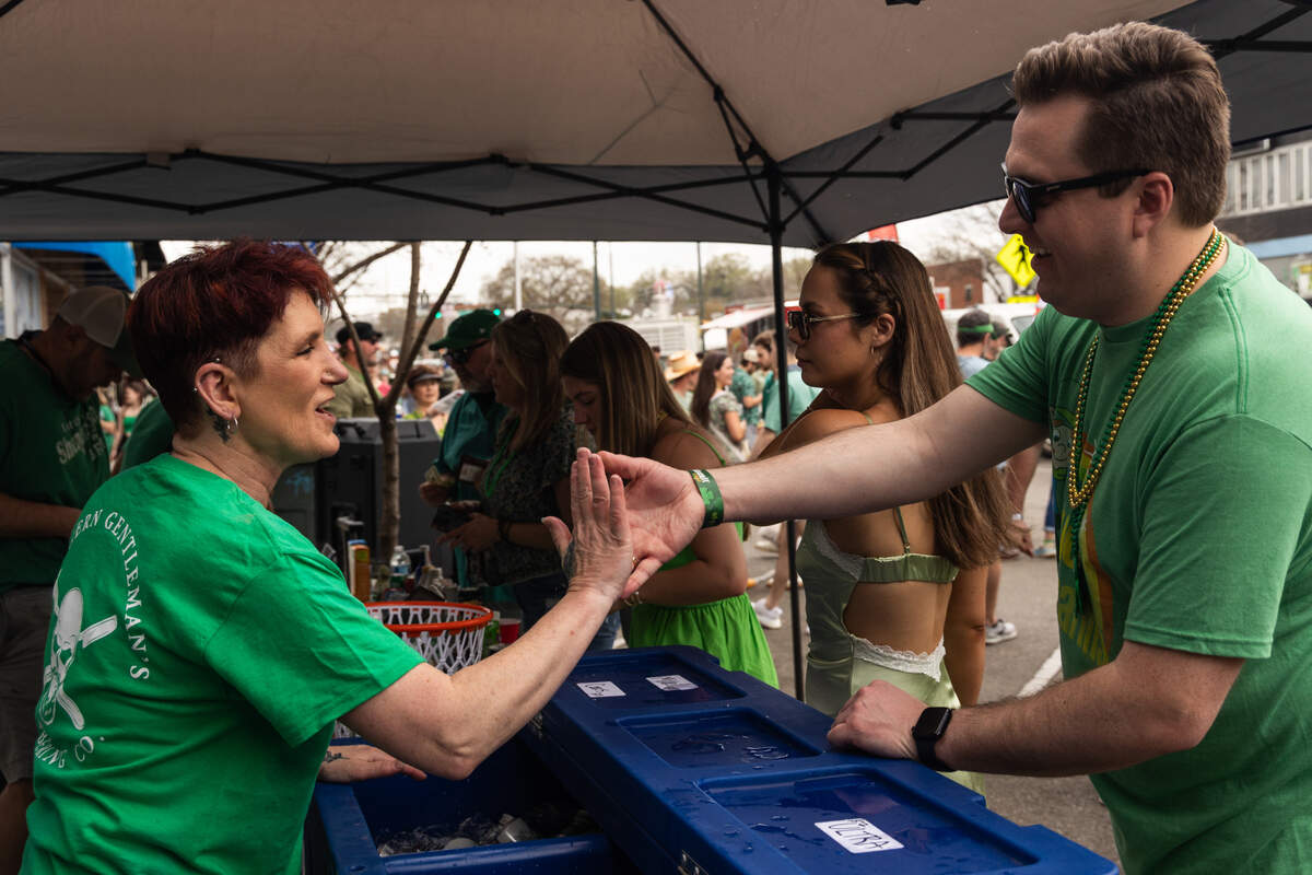 People purchase wine and beer from street vendors during the St. Pat’s in Five Points festival in Columbia, South Carolina on Saturday, March 15, 2025.