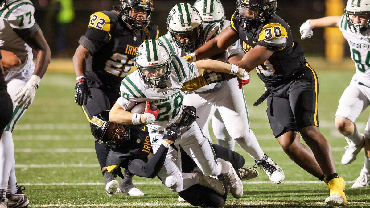 Kyle Henry (28) of Dutch Fork gets brought down during Irmo’s game against visiting Dutch Fork in Columbia on Friday, October 31, 2025.