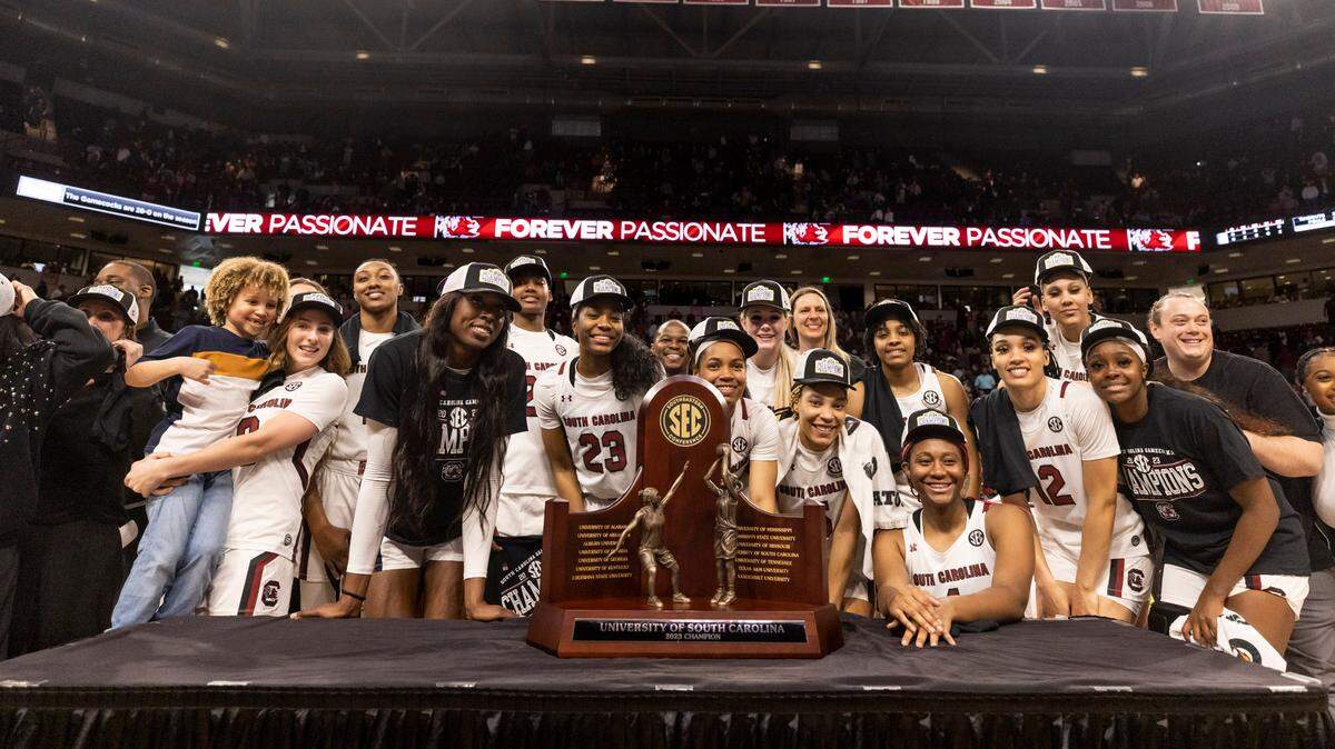 Gamecock players pose for a photo with the SEC regular-season championship trophy following South Carolina’s game against the visiting Bulldogs at Colonial Life Arena in Columbia on Sunday, February 26, 2023.