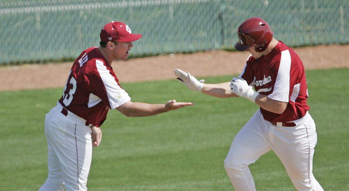 From 2008: Then-USC assistant Monte Lee congratulates Phil Disher after a grand slam against Mississippi State University in a game played at Sarge Frye Field in Columbia.
