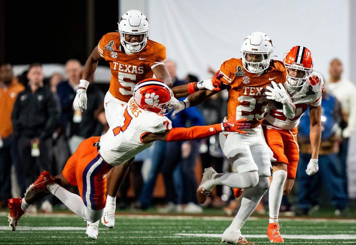Texas Longhorns running back Jaydon Blue (23) evades a tackle from Clemson Tigers safety Khalil Barnes (7) to run the ball in for a touchdown in the fourth quarter as the Texas Longhorns play the Clemson Tigers in the first round of the College Football Playoffs at Darrell K Royal Texas Memorial Stadium in Austin, Texas, Dec. 21, 2024.