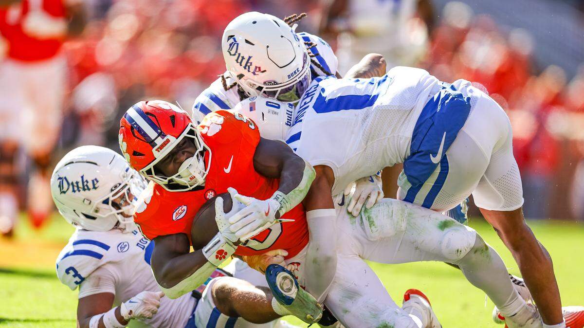 CLEMSON, SOUTH CAROLINA - NOVEMBER 01: Gideon Davidson #9 of the Clemson Tigers is tackled by Chandler Rivers #0 and Caleb Weaver #3 of the Duke Blue Devils during the second half of a football game at Memorial Stadium on November 01, 2025 in Clemson, South Carolina.
