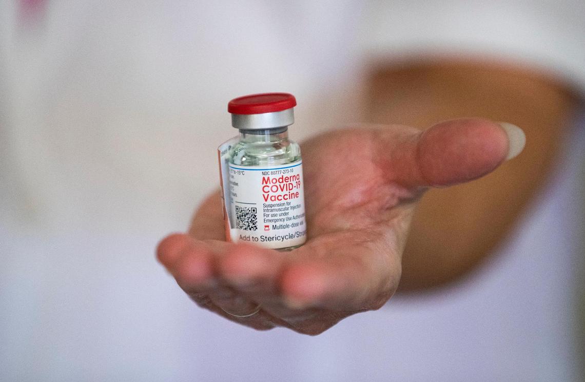 Pharmacist Ginger Cates holds a recently defrosted coronavirus vaccine at Wellmore of Lexington on Wednesday, December 30, 2020. Residents and staff received the first of two shots Wednesday.