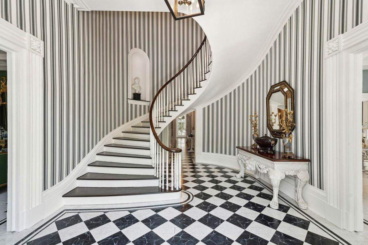 The main staircase in a $12.5 million Charleston home for sale.