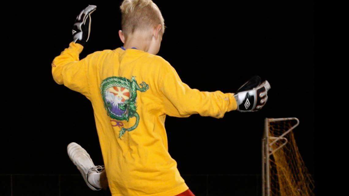 Lexington native Hunter Gilstrap works a drill with Owen Petersen, 8, during a group lesson Gilstrap taught at the South Carolina United FC Junior Academy.