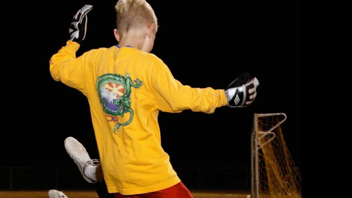 Lexington native Hunter Gilstrap works a drill with Owen Petersen, 8, during a group lesson Gilstrap taught at the South Carolina United FC Junior Academy.