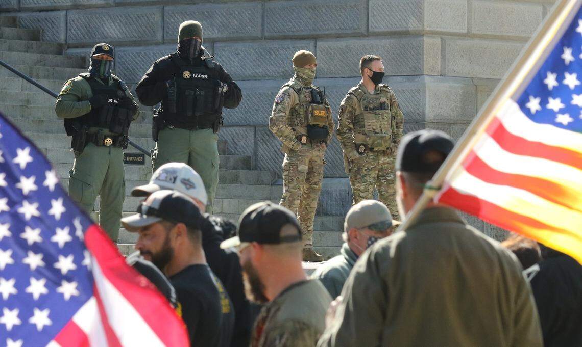 Protesters peacefully gather on the grounds of the South Carolina State House under the watch of law enforcement.