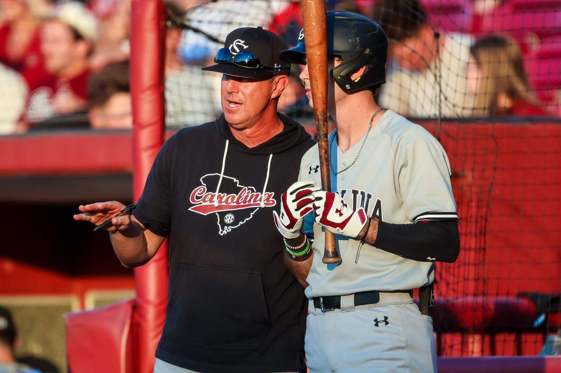 South Carolina Gamecocks head coach Mark Kingston instructs outfielder Dylan Brewer (10) during an NC State Wolfpack pitching change in their 2023 NCAA Columbia Regional game at Founders Park in Columbia, SC, Saturday, June 3, 2023.