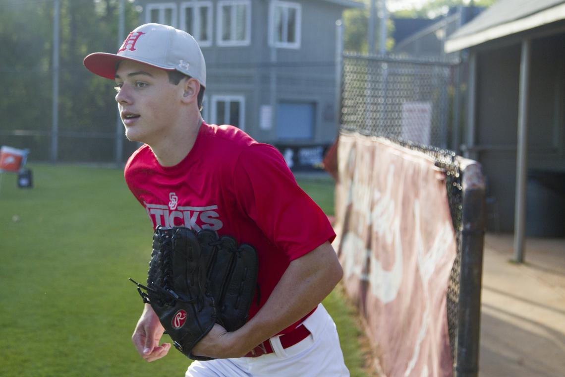 Hammond's Reece Holbrook grabs his glove for practice at Hammond School on Wednesday April 11, 2018, in Columbia, SC. Holbrook is the son of former USC baseball coach, Chad Holbrook, and will be following in his father's footsteps to play for UNC at Chapel Hill. Reece's connection with the university goes back to his childhood when he was treated there for acute lymphoblastic leukemia.