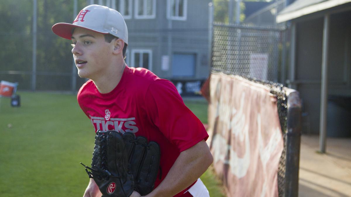 Hammond's Reece Holbrook grabs his glove for practice at Hammond School on Wednesday April 11, 2018, in Columbia, SC. Holbrook is the son of former USC baseball coach, Chad Holbrook, and will be following in his father's footsteps to play for UNC at Chapel Hill. Reece's connection with the university goes back to his childhood when he was treated there for acute lymphoblastic leukemia.