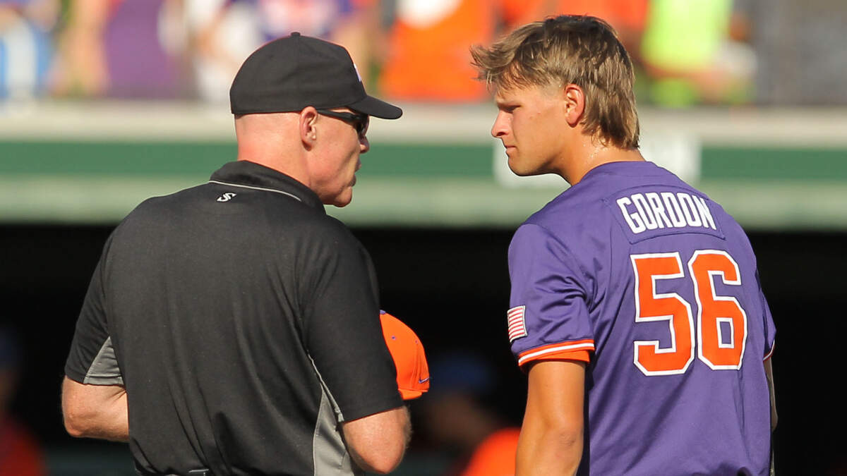 An umpire talks with Clemson’s Austin Gordon during NCAA Super Regionals action on Sunday, June 9, 2024 in Clemson, S.C. (Travis Bell/SIDELINE CAROLINA)