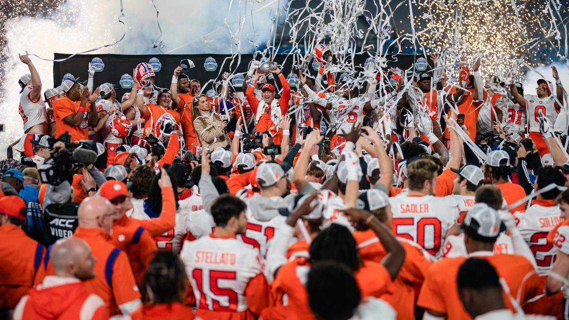 Clemson coach Dabo Swinney holds up the trophy after Clemson defeated North Carolina in the Atlantic Coast Conference championship NCAA college football game Saturday, Dec. 3, 2022, in Charlotte, N.C. (AP Photo/Jacob Kupferman)