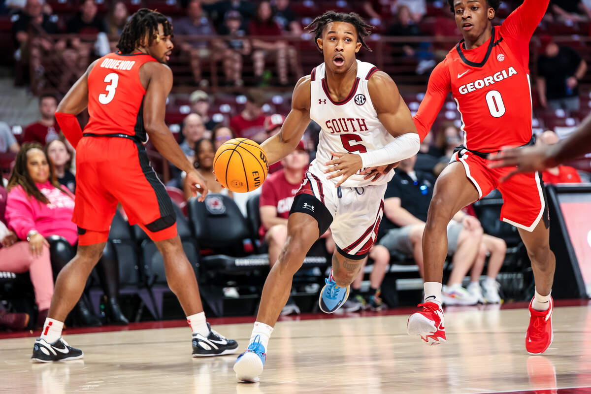 South Carolina Gamecocks guard Meechie Johnson (5) drives past Georgia Bulldogs guard Terry Roberts (0) in the first half at Colonial Life Arena.
