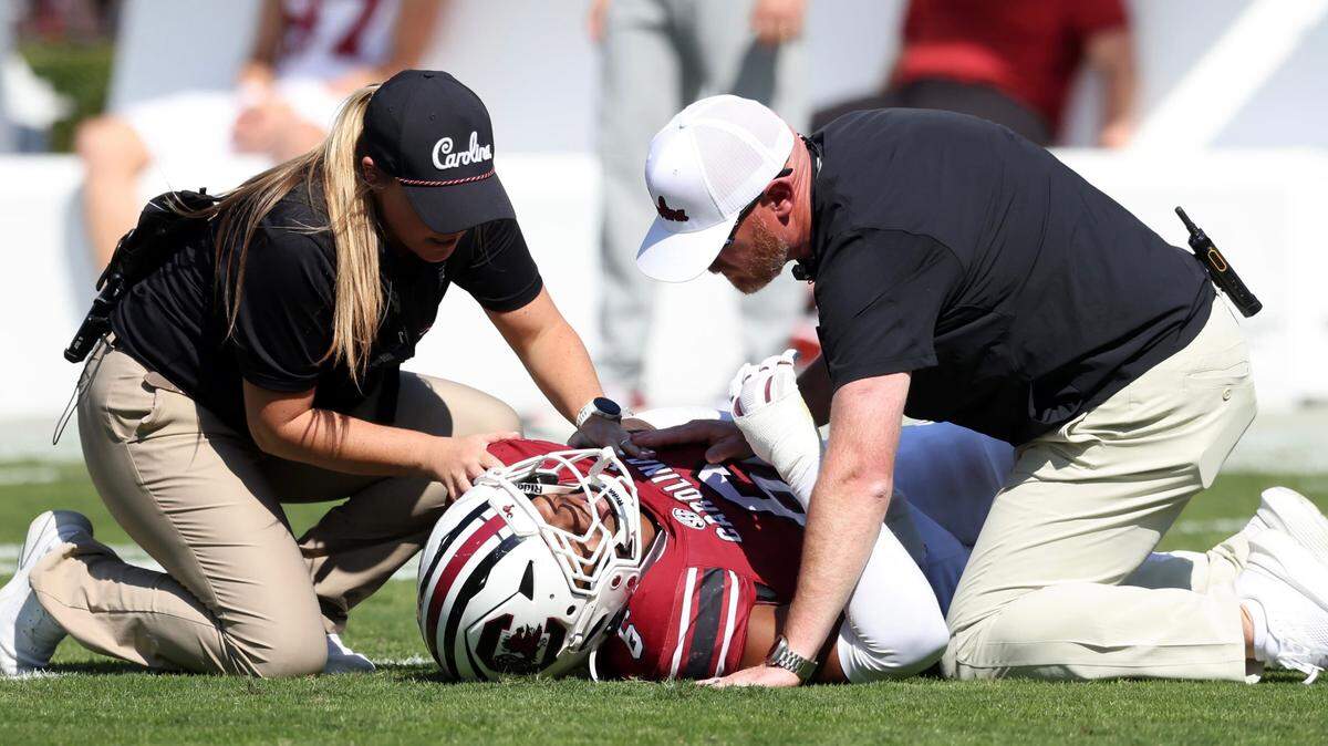 South Carolina trainers check on injured defender Dylan Stewart in the first half of Saturday’s game against Oklahoma.