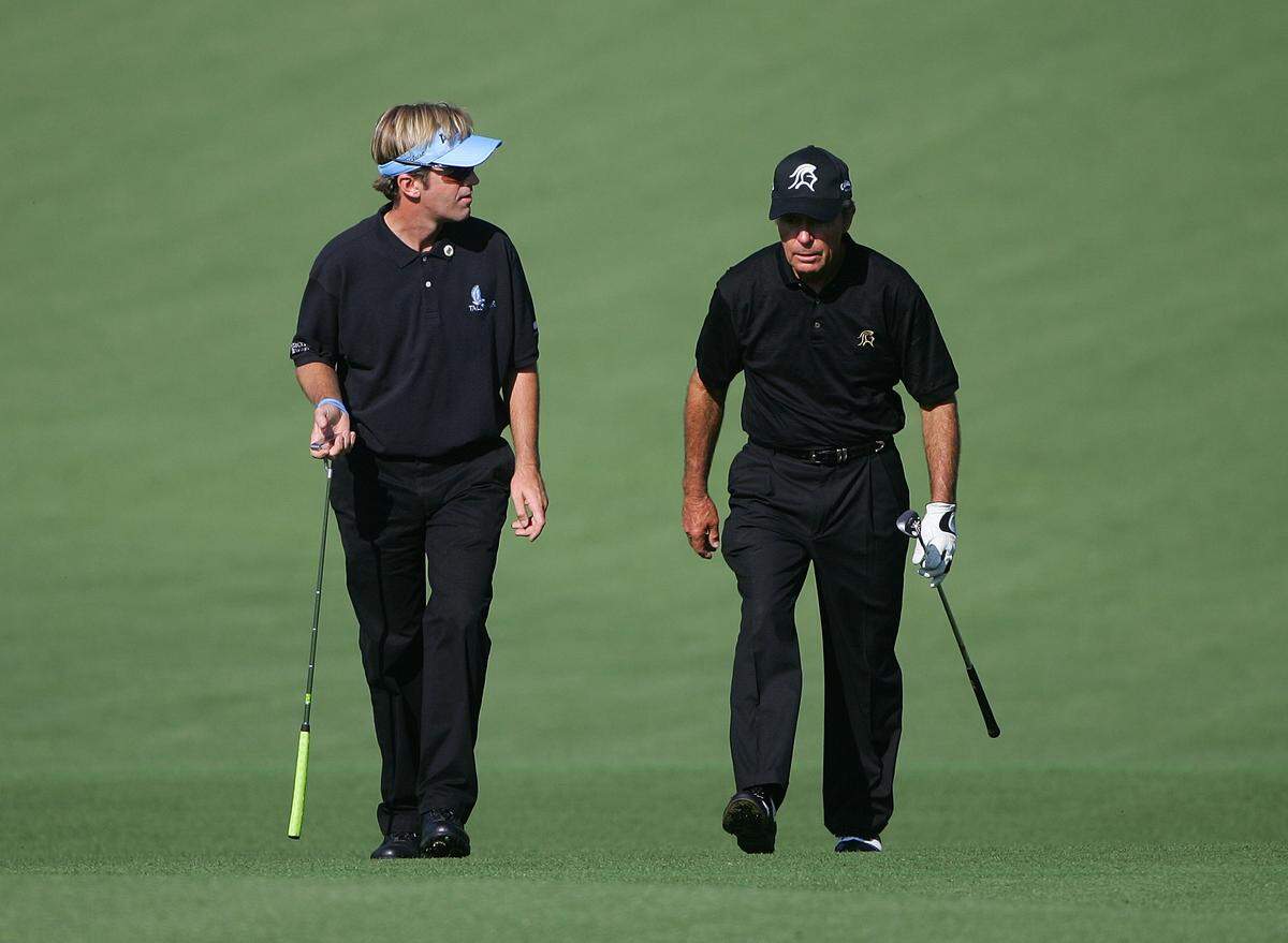 Brett Quigley (L) walks up the ninth fairway with Gary Player during the first practice day prior to the start of The Masters at Augusta National Golf Club April 2, 2007.