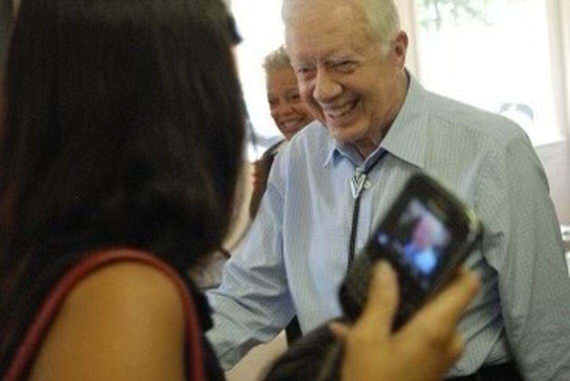 Former President Jimmy Carter says hello to Mandy Powers Norrell in 2009 at Mom’s Kitchen in Plains, Georgia, where they both happened to be having lunch after Norrell attended Carter’s Sunday school.