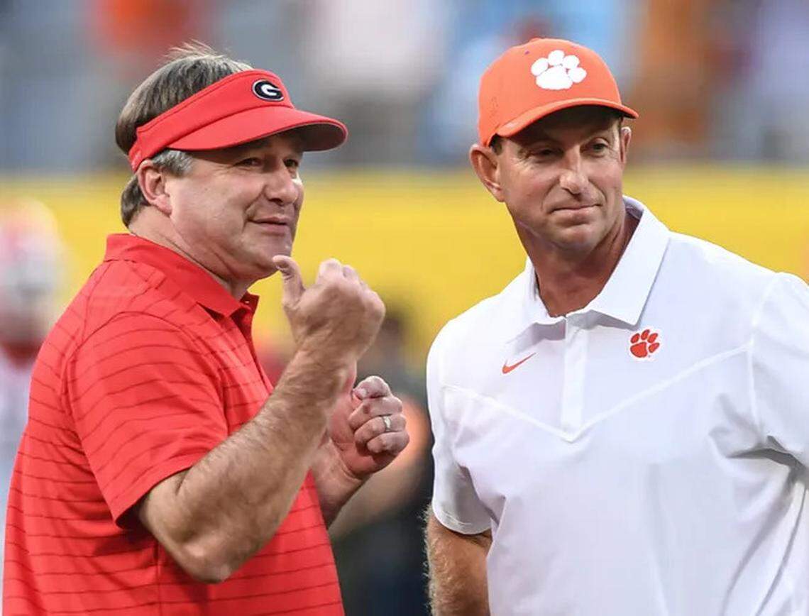 Georgia football coach Kirby Smart (left) and Clemson football coach Dabo Swinney (right) speaking before the 2021 Duke’s Mayo Classic in Charlotte, North Carolina