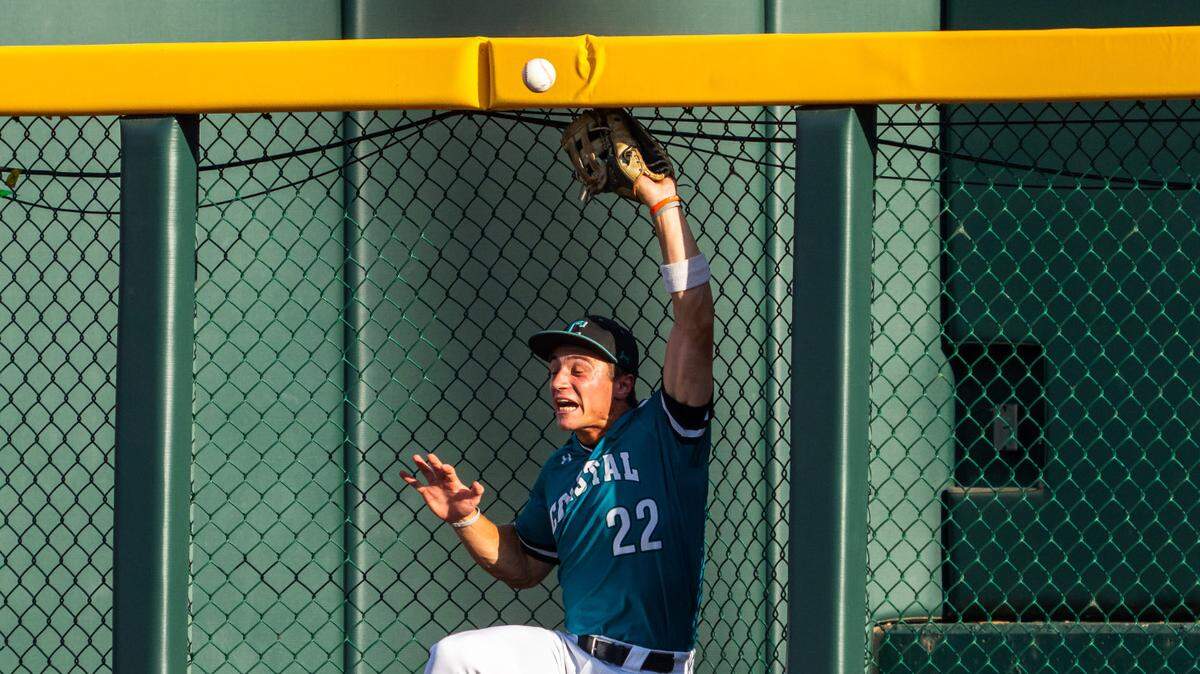 Coastal Carolina Chanticleers right fielder Blagen Pado (22) hits the bullpen while missing a fly ball during the third inning against the LSU Tigers at Charles Schwab Field.