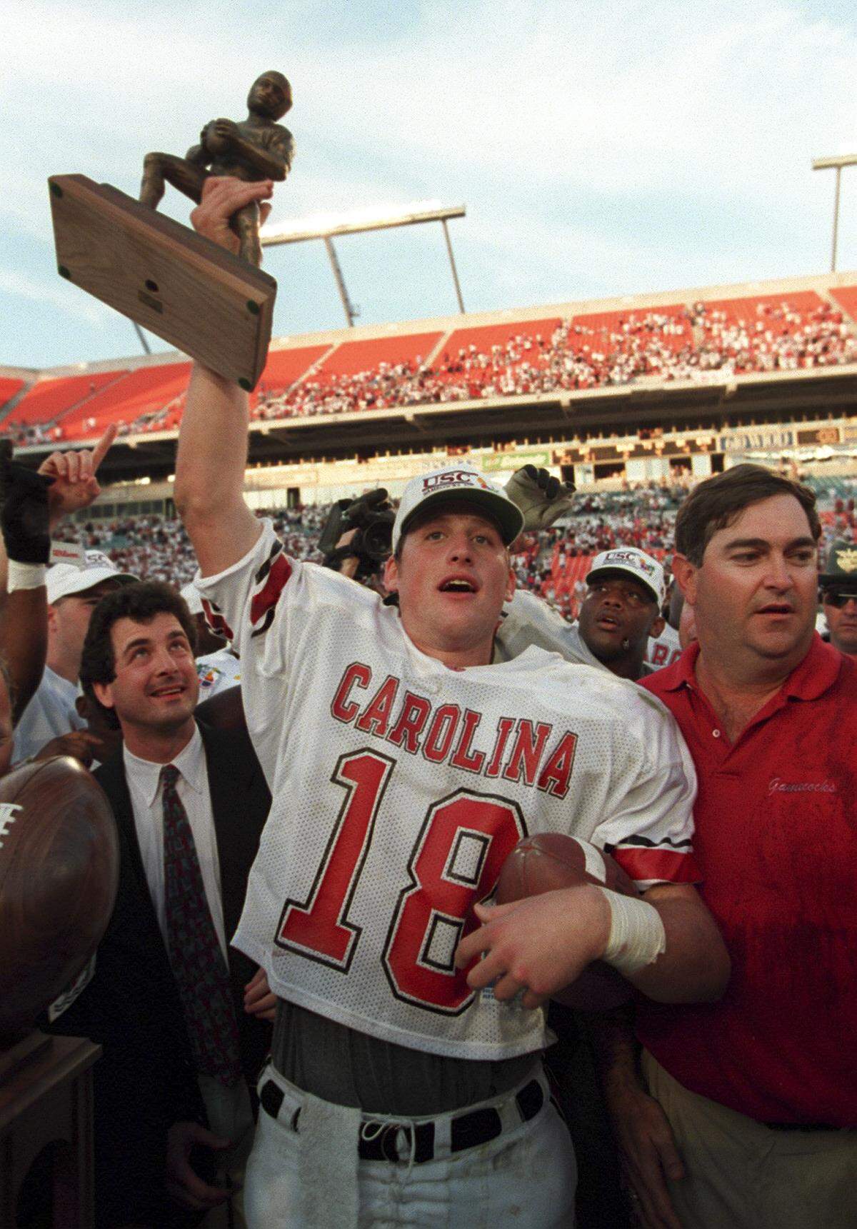 South Carolina quarterback, Steve Taneyhill displays his MVP trophy at the 1995 CarQuest Bowl with head cCoach Brad Scott by his side.